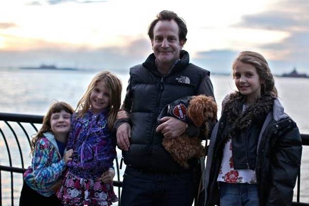 Photograph of Matthew Badger with his daughters Grace, Sarah and Lily